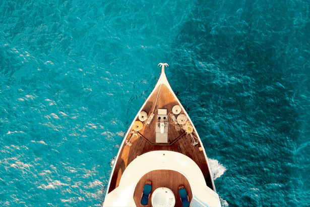 Aerial view of a luxurious cruise ship gliding through the deep blue ocean waters planned by My Tailored Escape cruise travel agency.