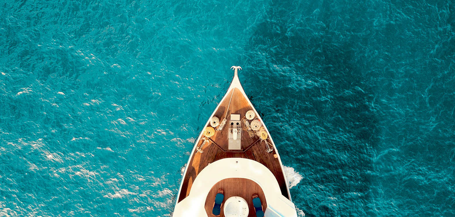 Aerial view of a luxurious cruise ship gliding through the deep blue ocean waters planned by My Tailored Escape cruise travel agency.