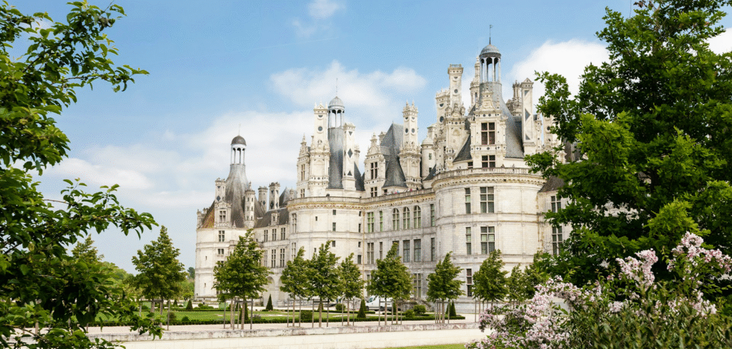 Majestic Château de Chambord, a stunning Renaissance castle in the Loire Valley, France, surrounded by lush gardens.