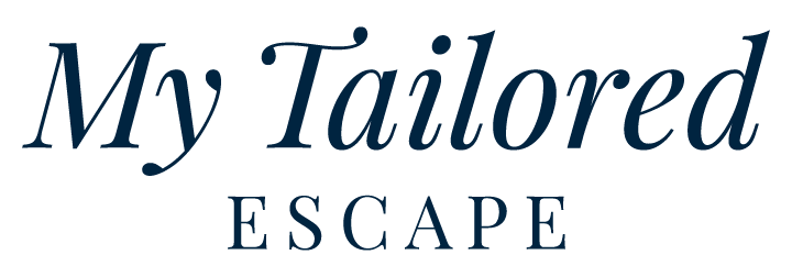 Navy colored logo that reads, "My Tailored Escape" in a classic, elegant font.