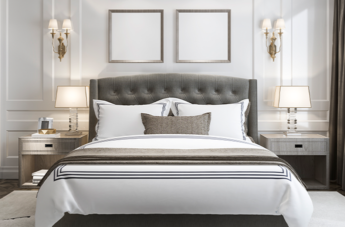 A serene, luxurious, high-end bedroom with a white bed and two stylish lamps, providing a calm and comfortable space for relaxation.