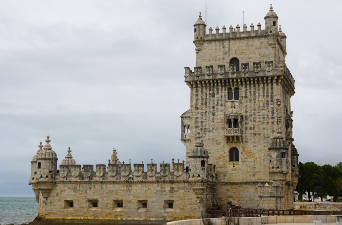 Belem Tower, highlighted by its distinctive clock tower against a scenic riverfront.
