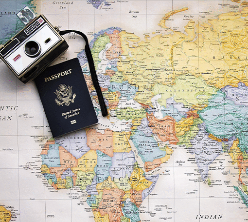A world map featuring a travel passport and camera, highlighting the excitement of travel and discovery.