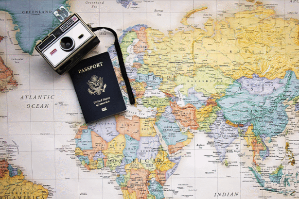 A world map featuring a travel passport and camera, highlighting the excitement of travel and discovery.