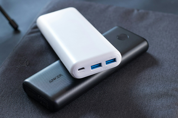 Two external power banks stacked on top of each other featuring two USB ports for charging multiple devices simultaneously.