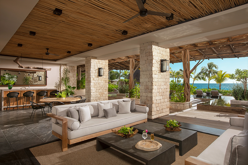 Oceanfront presidential villa terrace with luxury lounge seating and palm tree views at Impressions by Secrets — all-inclusive luxury resort booking by My Tailored Escape, travel advisor serving Washington DC, Maryland, Virginia and nationwide