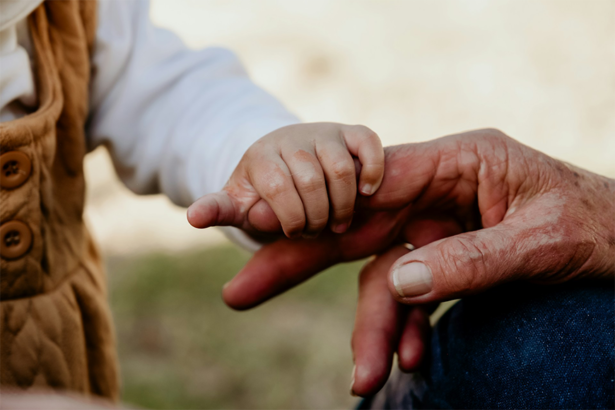 Baby and grandparent holding hands outdoors — multigenerational family vacation planning by Antoinette Harris of My Tailored Escape, luxury travel advisor serving Washington DC, Maryland, Virginia and nationwide