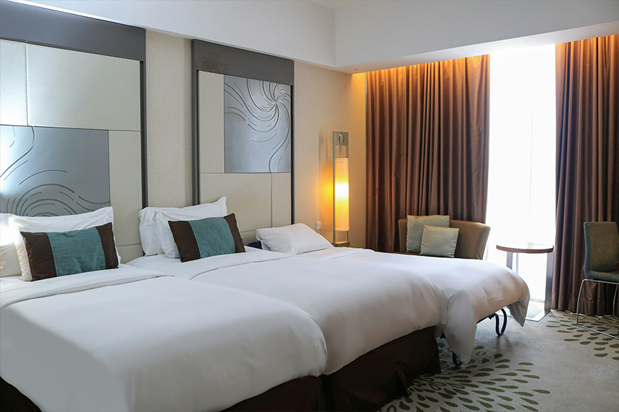 Spacious luxury hotel room with three beds and upscale decor — multigenerational and group travel accommodations booked by My Tailored Escape, boutique travel agency serving Washington DC, Maryland, Virginia and nationwide
